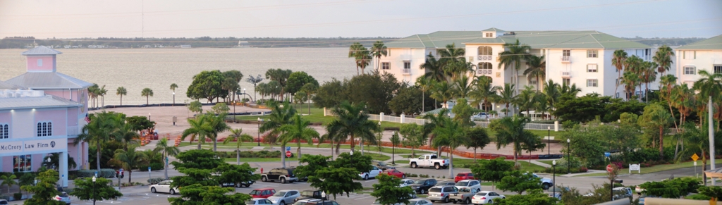 view of the harbor and surrounding buildings and cars