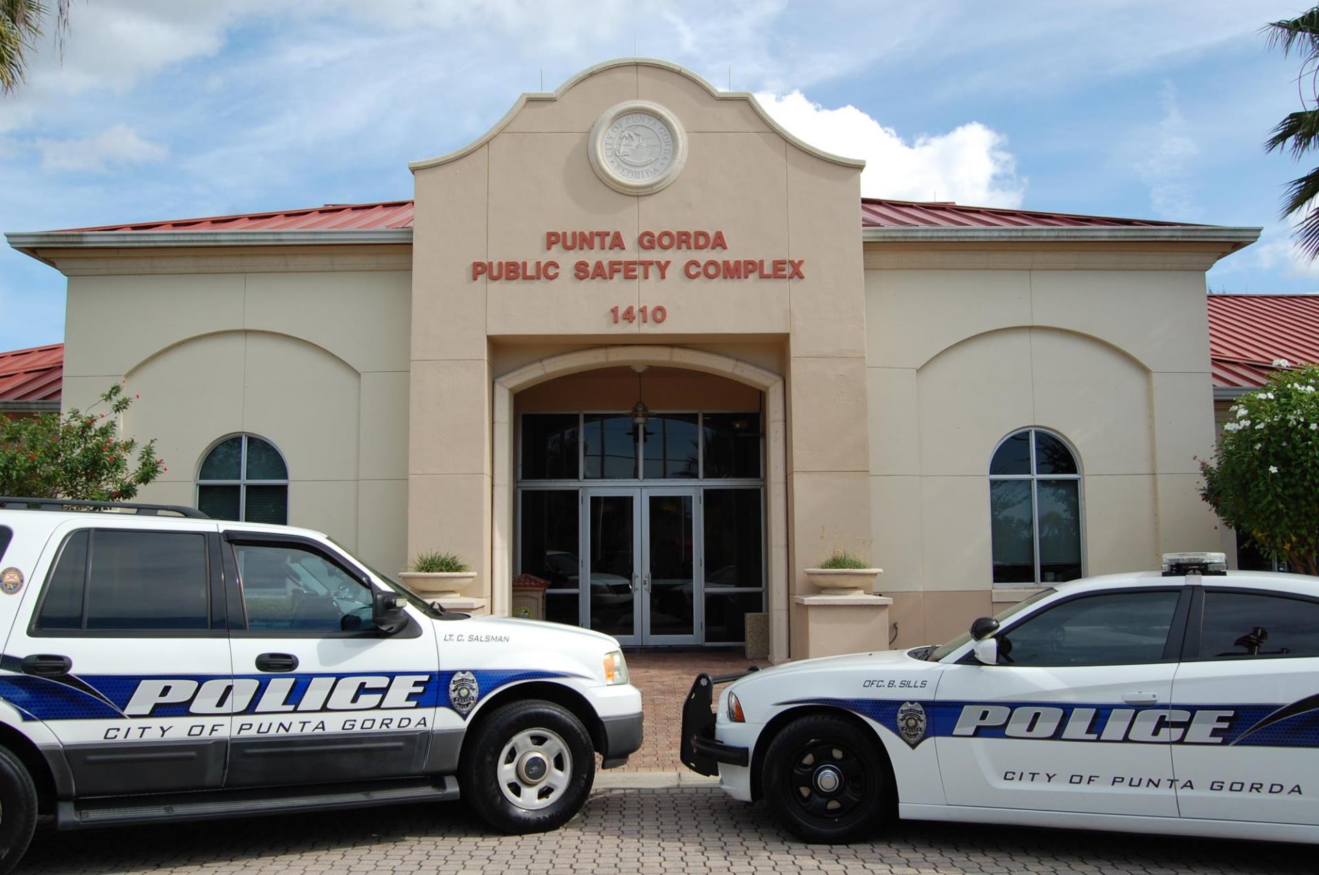 Photo of Public safety building with two police cars parked in the front of building