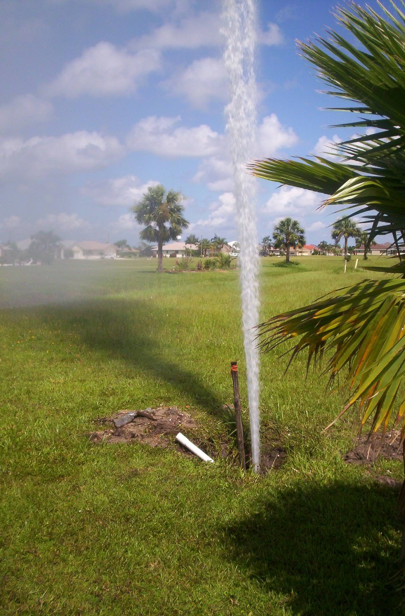 Water shooting up from a hole the ground 