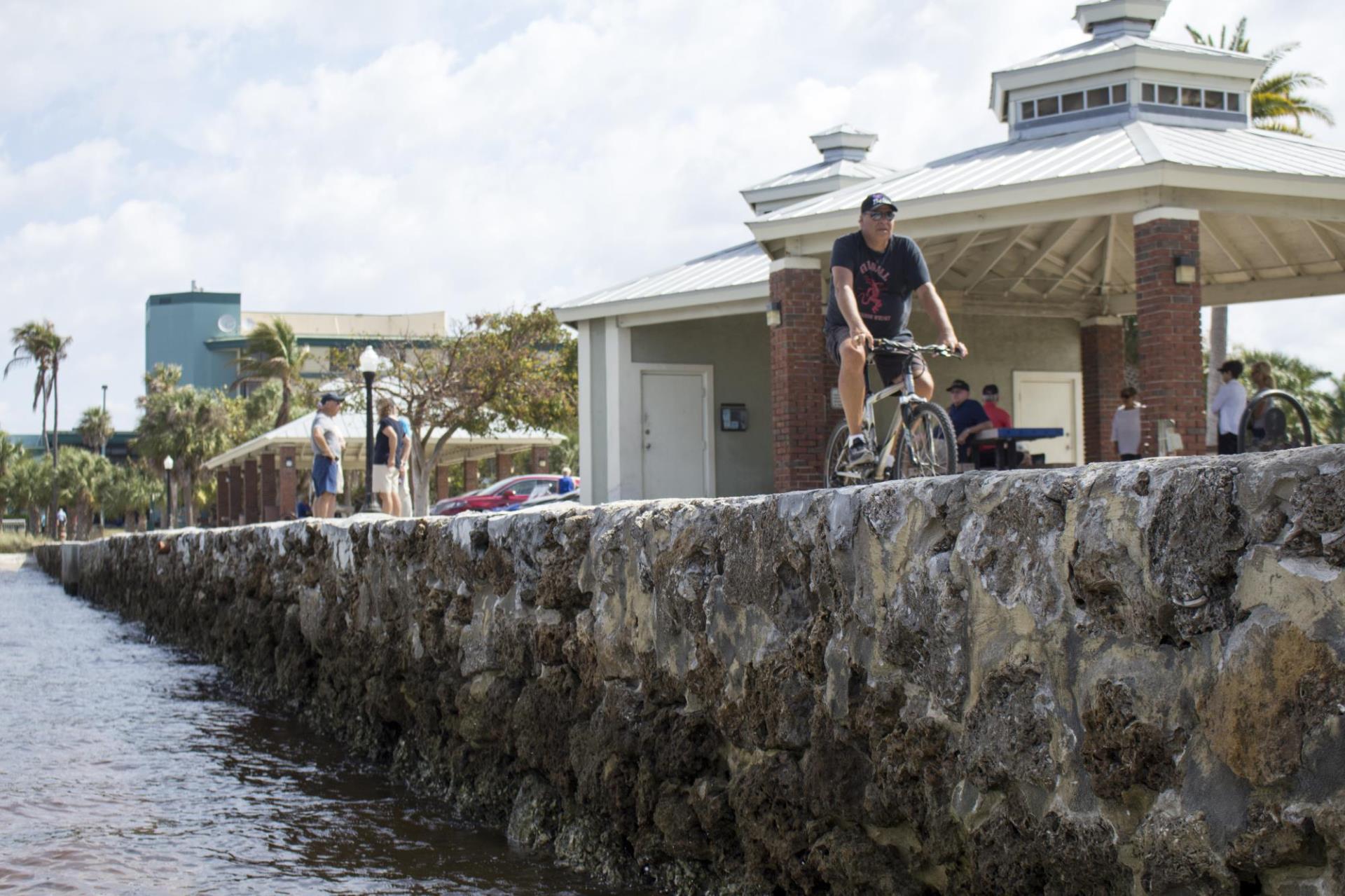 person biking along harbor at gilchrist park 