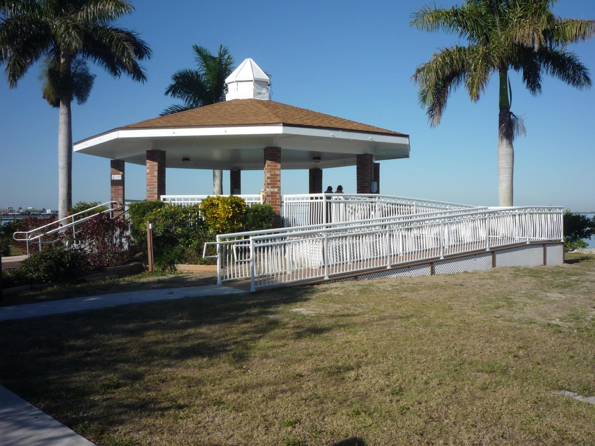 gazebo with people in it along the harbor 