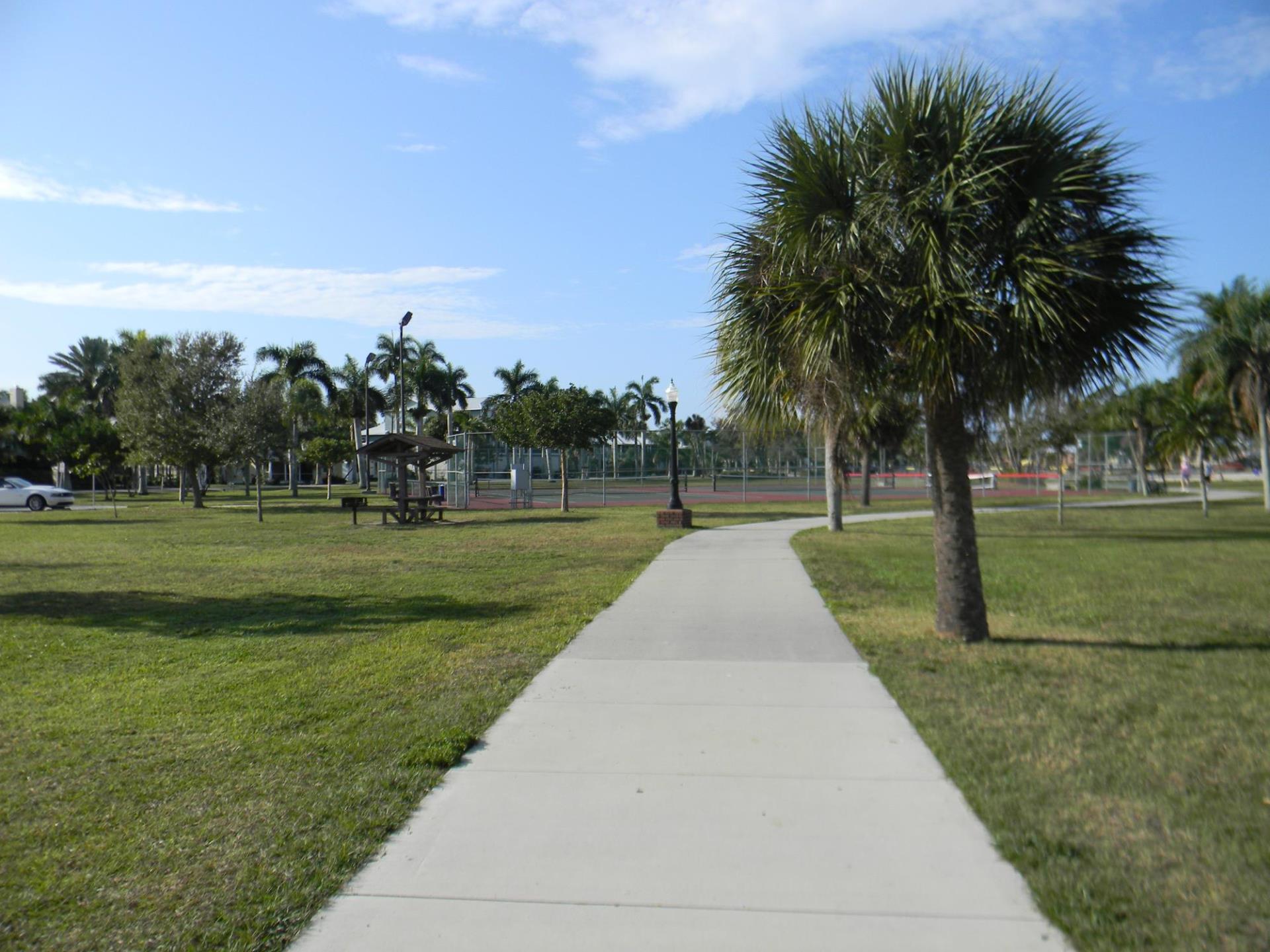 gilchrest park with tennis courts, sidewalk, and picnic table