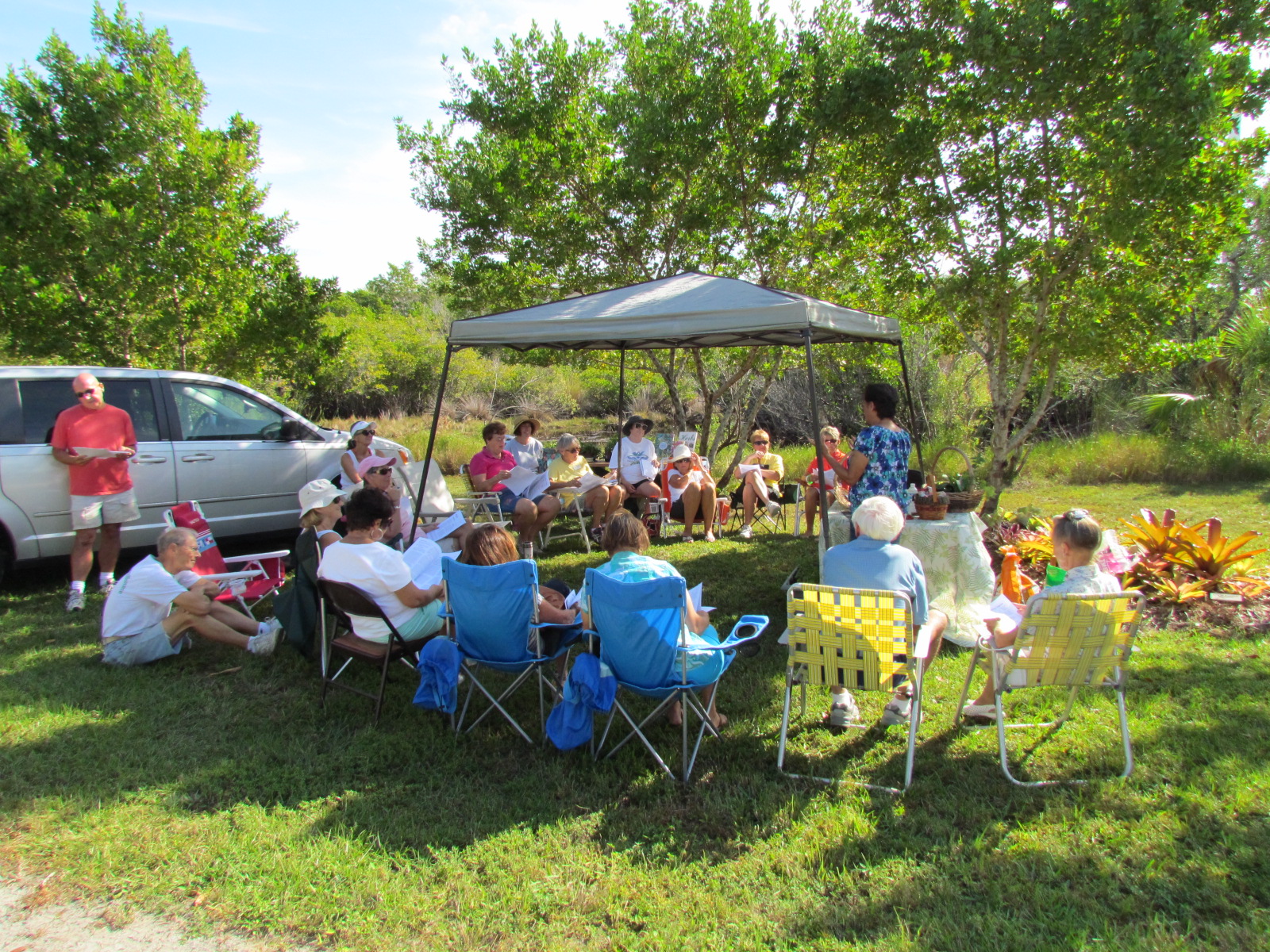 woman in nature park teaching to a group of people