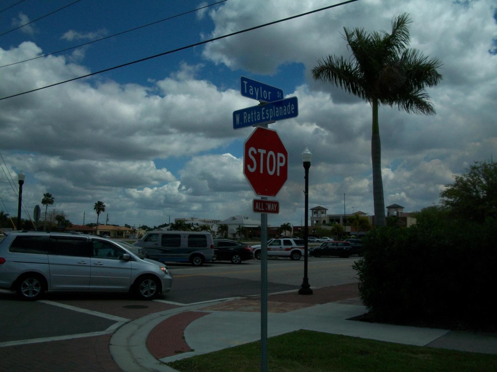 Intersection with cars and street signage.