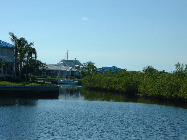 Image of BSI Perimeter Canal, water, boats, housing.