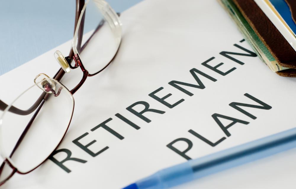 Photo of paper with retirement-plan-with-pen-and-glasses